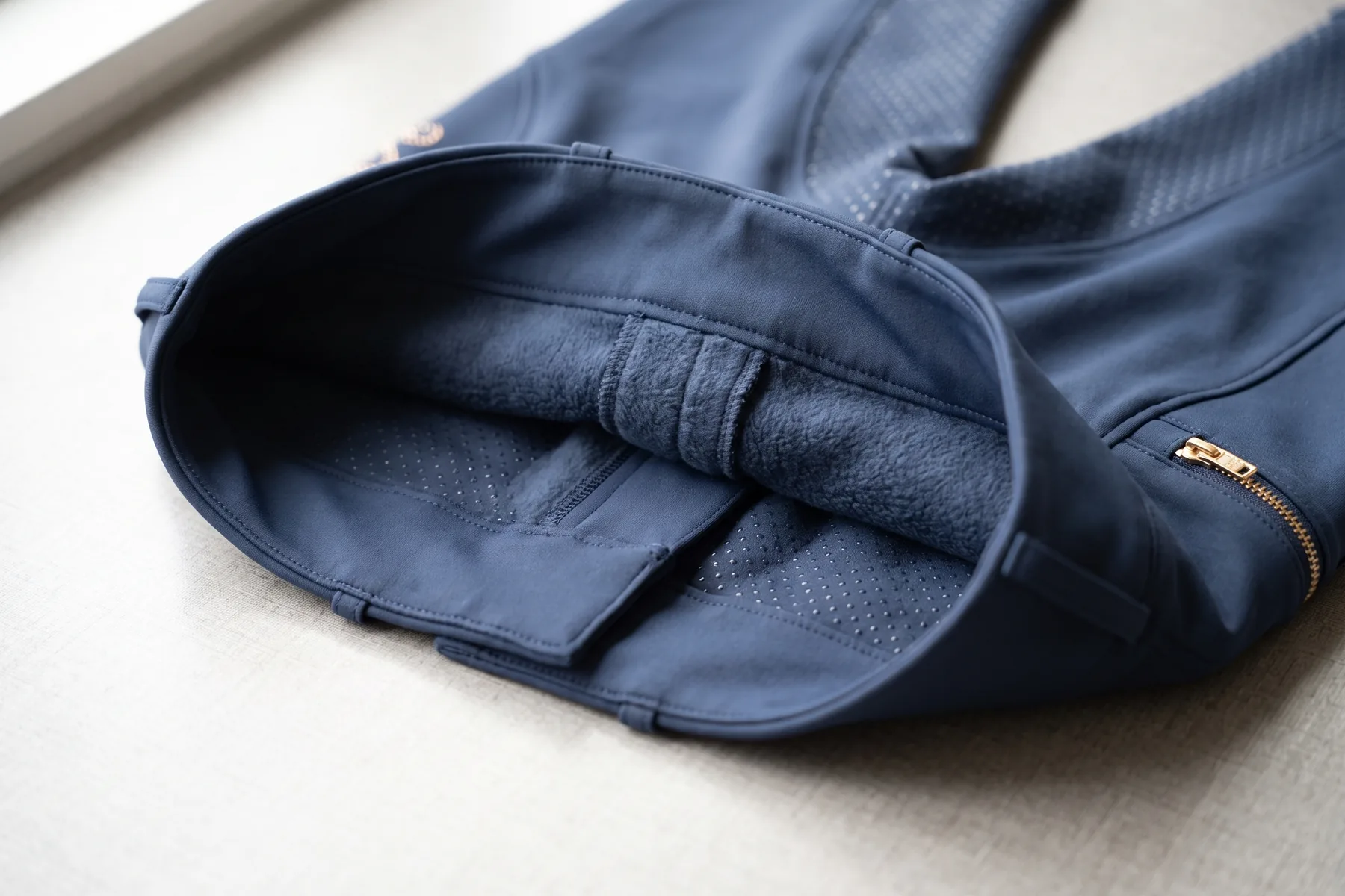 Ceinture ouverte d’un pantalon d’hiver marine montrant la doublure polaire